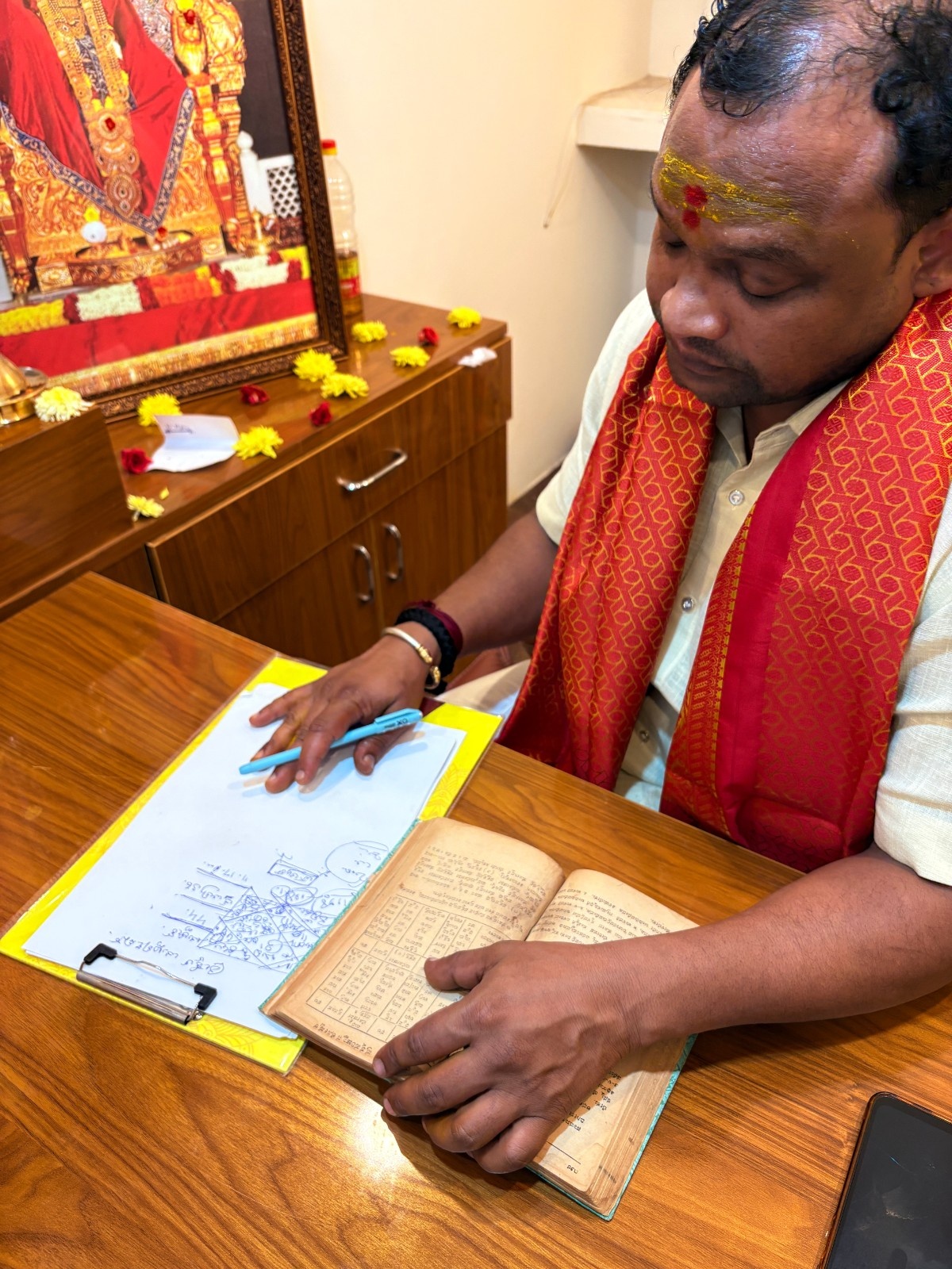 Astrologer reviewing a chart with sacred texts